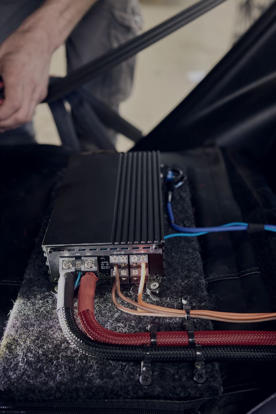 Amplifier and wiring being installed under a seat