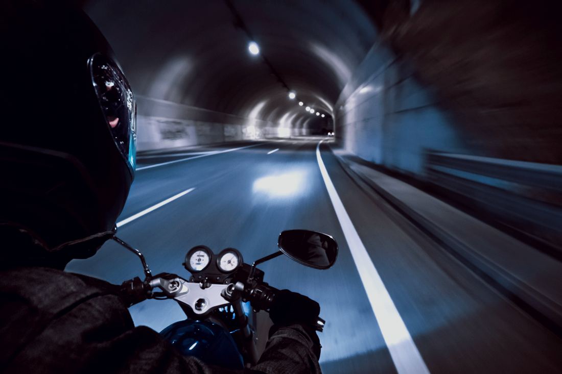 Motorcycle rider on the road at night