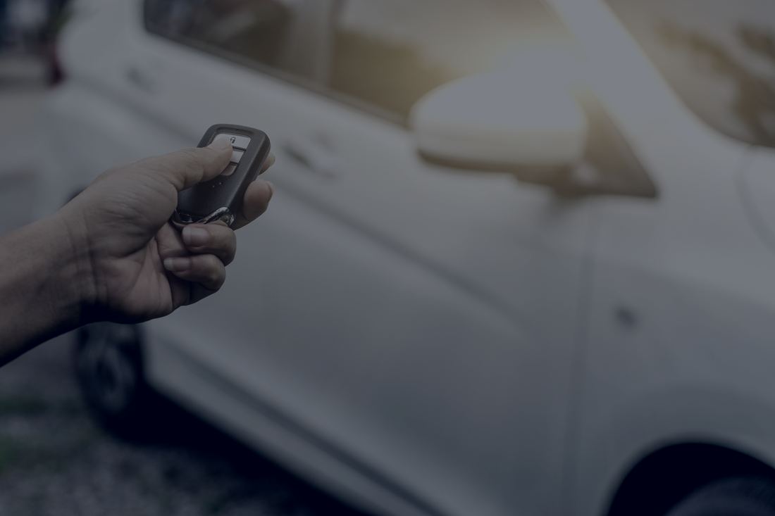 Driver using a remote to lock a vehicle